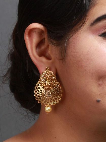 A model looking elegant in our golden filigree earrings.