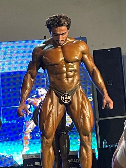 My client on stage at the Aman Classic, showcasing his physique.