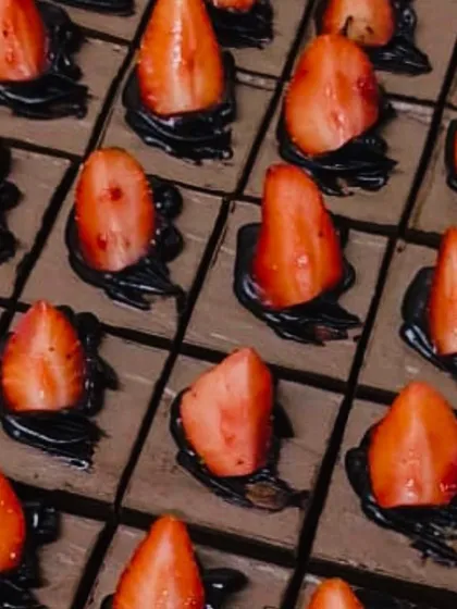 A dessert island of chocolate and strawberries. These rich chocolate mousse squares are topped with fresh strawberries for a classic and irresistible combination.