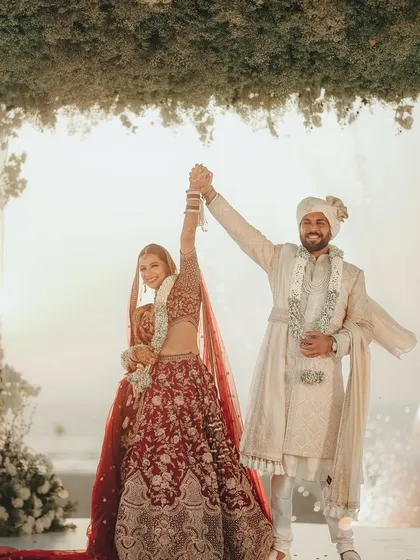 That "we did it" feeling! A celebratory moment from a beautiful beach wedding in Goa, right after the Varmala exchange.