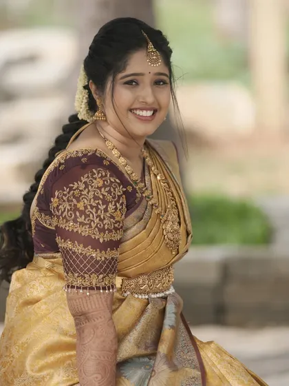 A joyful bride during her welcome ceremony. The makeup is bright and fresh, with a focus on glowing skin.