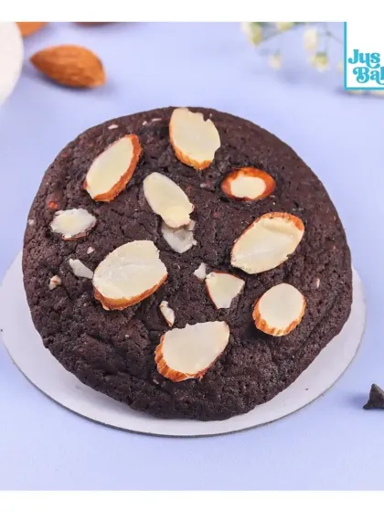 A close-up of the Almond Brownie Crinkle Big Cookie. The contrast between the dark cookie and the light almonds is beautiful.