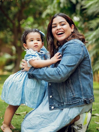 A beautiful mother-daughter moment during an outdoor family photoshoot. The genuine laughter and embrace say it all.