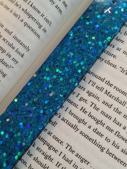 A detailed close-up of the holographic glitter in the blue bookmark, showing how it catches the light.