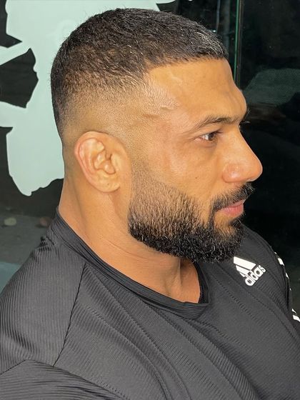 Another angle of this powerful skin fade, showing the seamless blend and sharp lines.