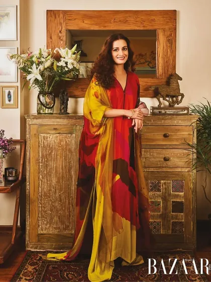 When I designed Dia Mirza's home, it was about creating a space that could hold all the art and furniture she had collected over the years. This corner, with its rustic wooden console and beautiful flowers, perfectly reflects her warmth, grace, and quiet strength.
