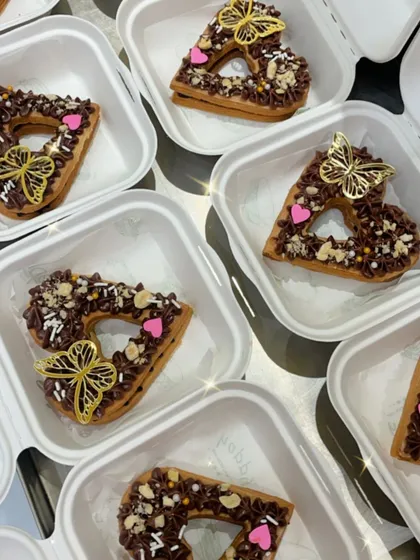 My mini bento tarts are perfect for Valentine's Day. These are heart-shaped cookie tarts filled with rich chocolate and decorated with edible butterflies and sprinkles, packed in individual boxes.