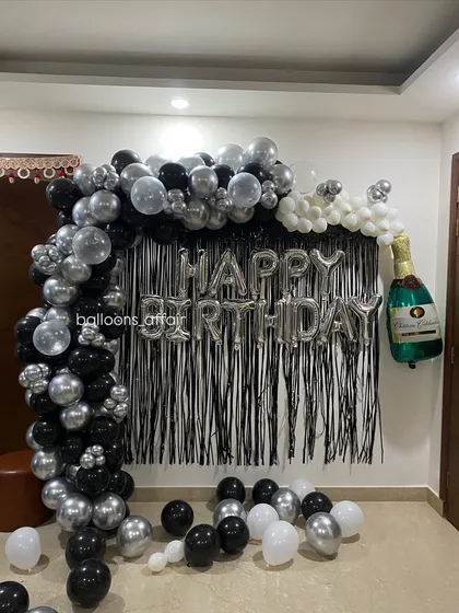 This angle shows the depth of the balloon arch and how it frames the "Happy Birthday" message perfectly for photos.
