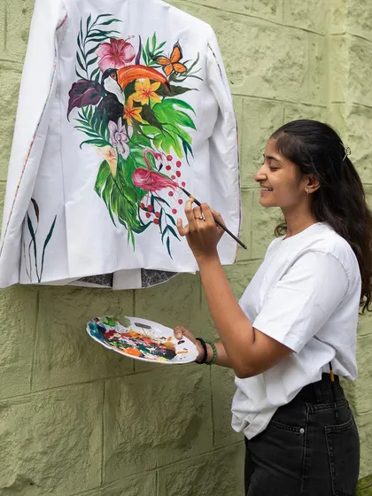 Me happily at work on the forest-themed blazer. This piece is a perfect example of how I infuse love and energy into every brushstroke.
