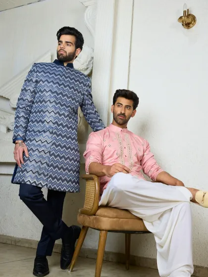 A full look at the blush pink kurta with mirror work, paired with a classic white dhoti-style bottom. The combination is both traditional and effortlessly stylish.