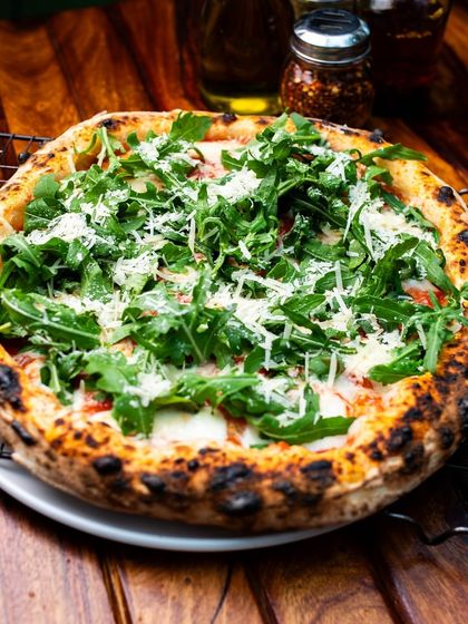 Rucola magic! Our Grana e Rucola pizza is fresh, vibrant, and bursting with flavour.