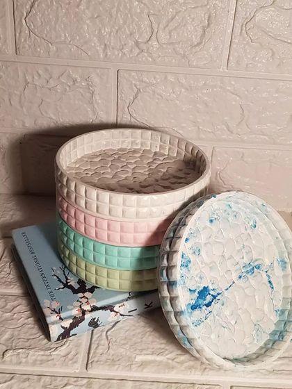 A stack of our round marshmallow trays, showing the different colors and the unique textured bottom.