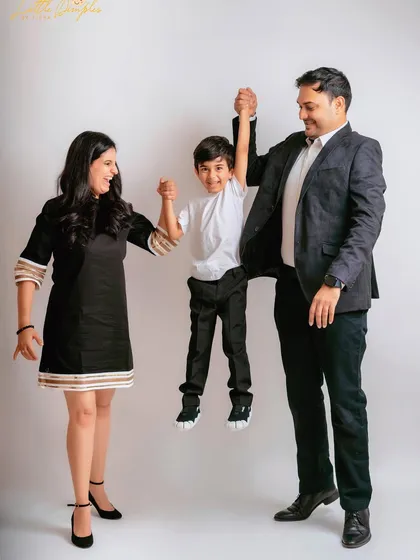 Pure fun! Swinging their son between them, this pose is full of movement and joy, perfect for capturing a family's playful side.
