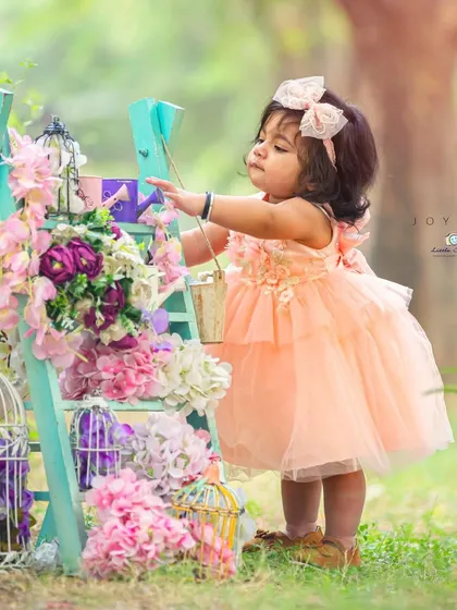 My storytelling setups invite children to interact and play. This image captures a moment of focused curiosity amidst a beautifully styled floral scene.