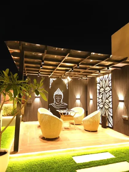 A wider perspective of the Sushant Lok pergola, showing its placement on the terrace and the beautiful ambient lighting.