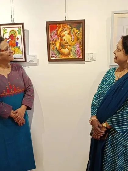 Discussing my Ganesha painting with a visitor at the IIWC gallery. I enjoy sharing the stories and techniques behind each artwork.