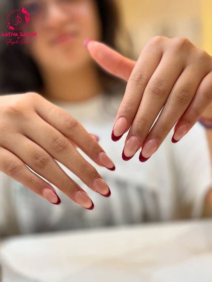 A modern twist on a classic. These almond-shaped extensions feature a deep, glossy red French tip, offering a bold and confident take on the traditional look.