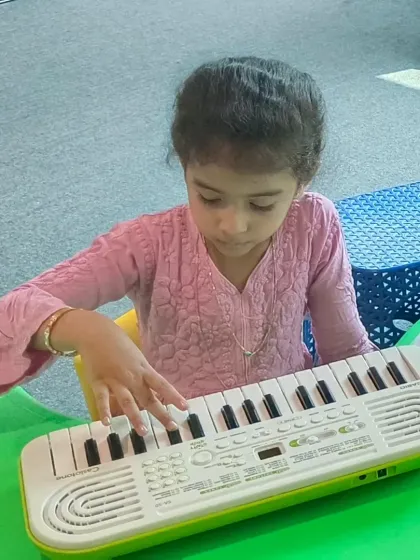 A young girl in our offline class gets familiar with the Casio mini keyboard. We provide a comfortable and supportive environment for the first day of music lessons.