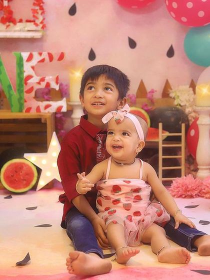 Big brother and little sister sharing a special moment during her watermelon-themed birthday shoot. I love including siblings in the celebration.