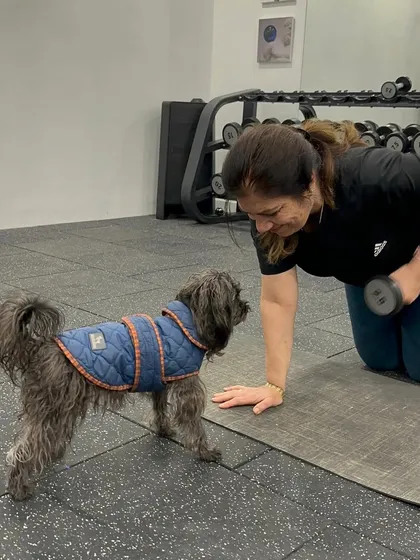 Our furry friends are the best motivators. A client gets some encouragement from her four-legged personal trainer during a set of dumbbell rows.