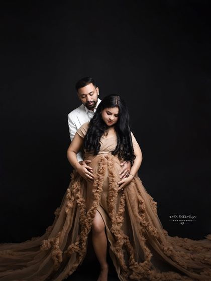 A dramatic and loving pose against a black background. This lighting creates a moody, intimate atmosphere that focuses on the couple's connection.