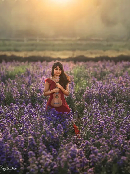 The magic of photography extends beyond the studio walls. This portrait, set in a field of lavender flowers under a golden sun, captures a sense of dreamlike wonder. It shows how we can use nature's canvas to create a whimsical and beautiful storybook moment.