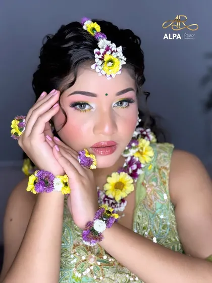A stunning close-up portrait of the bride-to-be, glowing in her Haldi makeup.
