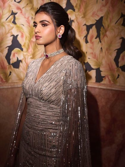 The side profile of this engagement gown shows off the beautiful fit and the delicate, shimmering texture. It’s a look that is glamorous from every angle.