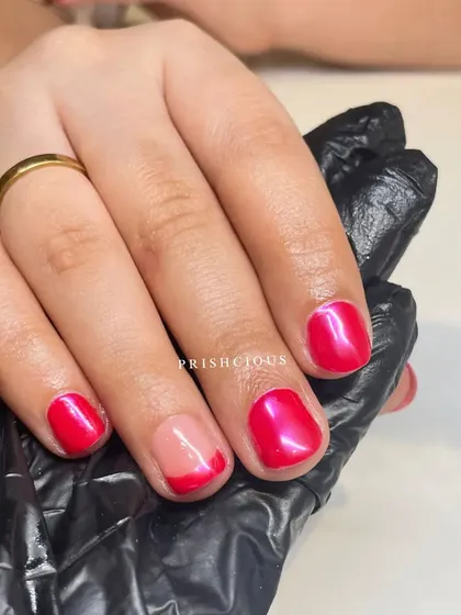 A unique combination of styles on natural nails. This look features a pink chrome effect, a modern French tip, and a solid pink nail.