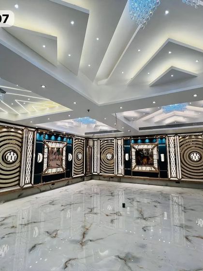 A wide shot of the empty Grand Utsav Banquet hall, showcasing the beautiful marble floor and the detailed, modern wall decor.