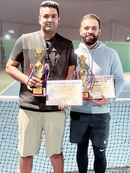 We practice what we preach. Here, my brother Kartikeya and I are celebrating our Men's Doubles title win at the East Delhi Open Tennis Tournament. We actively compete to stay sharp and bring that winning experience directly to our coaching sessions.