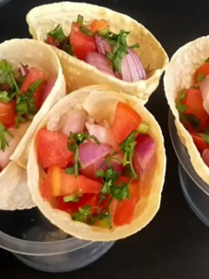 We love to innovate with classic Indian flavors. These masala papad cones are a creative twist on a beloved snack, filled with a fresh, tangy mixture of chopped onions, tomatoes, and herbs. They are a popular and convenient pass-around appetizer for cocktail parties.