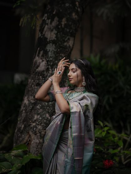 A moment of quiet elegance, the model's pose reflecting the sophisticated nature of this designer Kancheevaram silk.