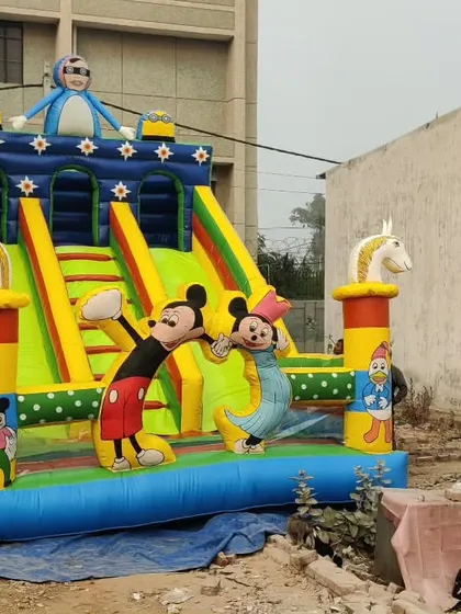 A dual-slide bouncy castle with horse figures and a Mickey Mouse theme. This shows how we can combine different elements into one design.