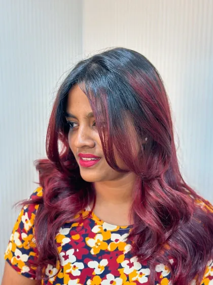 This client is glowing with her new cherry red balayage. It's a bold choice that paid off beautifully.