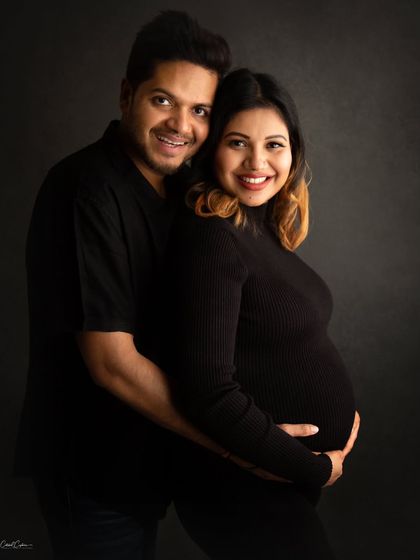 Such a happy and relaxed couple. This portrait in matching black outfits showcases their bright smiles and the love between them.