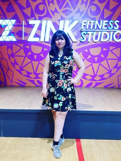 A member posing in front of our signature Zink wall. It's the perfect photo spot to capture that post-workout glow and feeling of accomplishment.