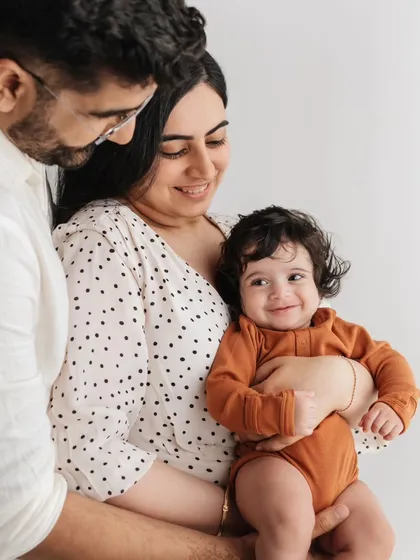 The sweetest smiles from both mom and baby. This close-up shot captures the beautiful connection between them during their family photoshoot.