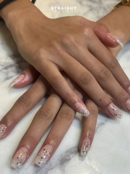 A look at a client's beautiful, long extensions with a subtle speckled design. Happiness is a fresh set of nails.