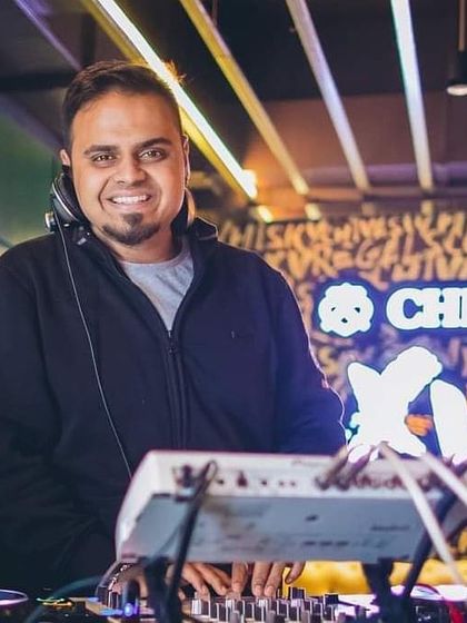 A smiling photo from the DJ booth, announcing my weekend gig schedule.