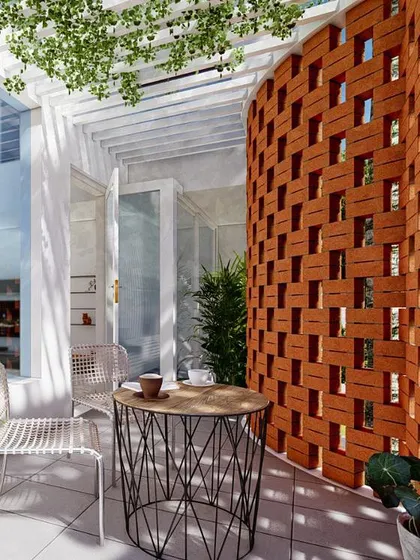 A close-up of a curved balcony featuring a clay block jali screen. This is a great way to control harsh sunlight while adding a raw, textural element to the building's exterior, enhancing the connection with nature.