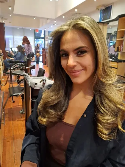 The client is happy with her fresh haircut and blowout. This style is easy to maintain and looks effortlessly chic.