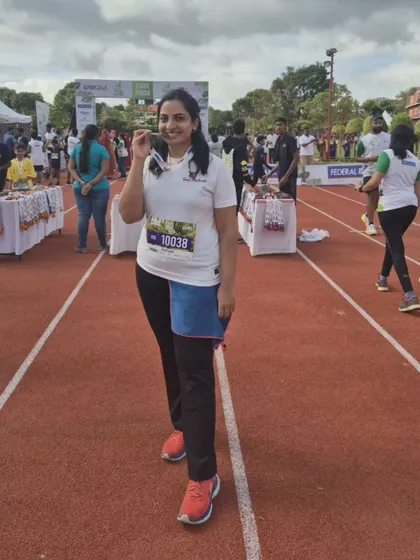 A proud moment for a Team Shushanth member, showing off her finisher medal at the Kodagu Monsoon Run.