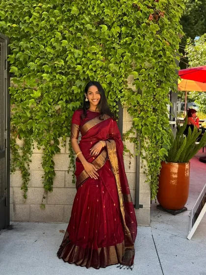 A glimpse into my client diaries with Rishika from the USA. She looks radiant in our viral maroon half saree. This shows how my personalized video consultations and custom fittings ensure a perfect result, no matter where you are in the world.