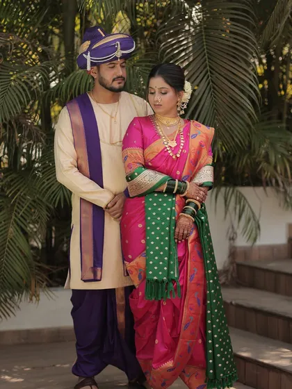 A classic portrait of the couple in their traditional Maharashtrian wedding attire.
