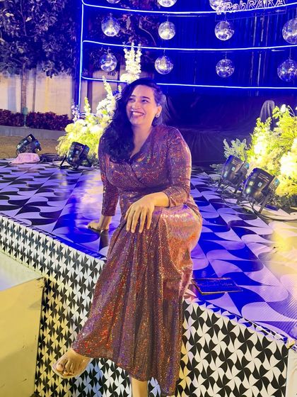 A relaxed photo on the stage after a successful Sangeet night. The disco balls and checkered floor set the scene for a night of dancing and celebration.
