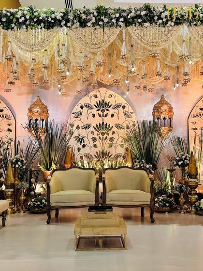 The central seating on the stage, perfectly framed by the golden lotus motif backdrop and traditional Moroccan-style lanterns.