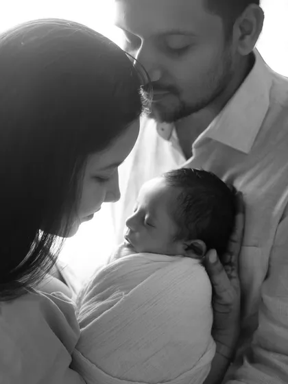 A quiet moment between new parents and their sleeping baby. The black and white edit enhances the feeling of peace and intimacy.