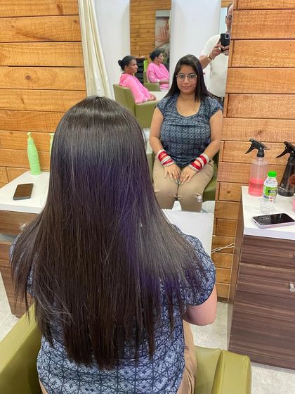 Here is the view from the chair. You can see the client admiring her newly smoothed and straightened hair in the mirror, looking happy with the results.