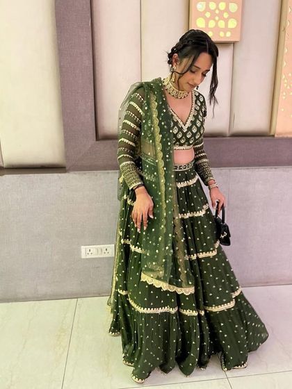 This client was styled for a wedding event in a custom tiered green lehenga with intricate gota patti work. Paired with a kundan choker, it's a chic and festive look.